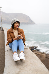 Woman enjoying a morning by the sea, reflecting and changing routine