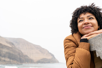 Woman enjoying a peaceful morning by the sea, reflecting and changing routine