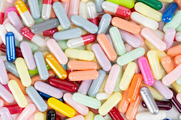Top view of colorful pills and capsules. Pharmaceutical background.