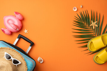 Bright vibrant arrangement of summer-themed items including a suitcase, sunglasses, sandals, and...