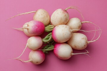Aerial view of freshly picked white radish on pink backdrop Nutritious low calorie vegetable Agriculture and health theme