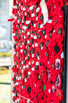 A banner of red knitted poppies
