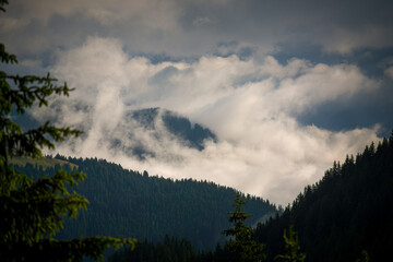 clouds anf fog over a valley, view from above at a summer morning