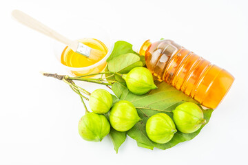 Fresh tung fruit and tung oil on white background