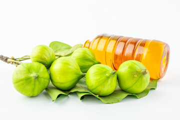 Fresh tung fruit and tung oil on white background
