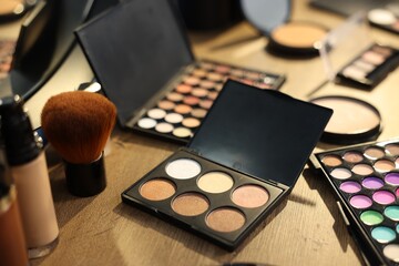 Different makeup products on wooden table, closeup