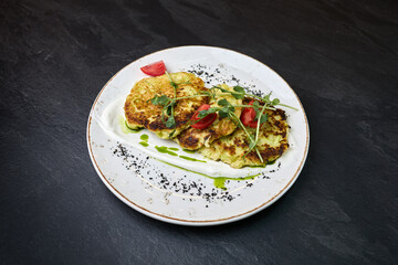 Zucchini fritters with yogurt sauce and microgreens
