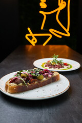 Gourmet open-faced steak sandwich in modern bistro