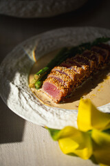 Grilled sliced tuna with asparagus and sesame in creamy sauce