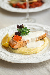Portion of gourmet salmon fillet steak with creamy sauce