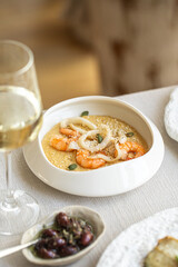 Portion of hummus with fried shrimps and squid rings appetizer