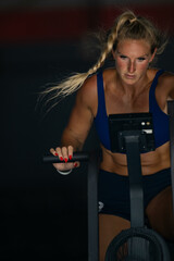 woman doing intense cardio training on exercise bike.