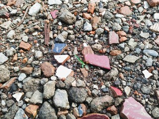 Close-up of small street stones, smooth dark brown gravel texture, gravel background