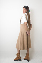 Elegant Female Model in Beige Designer Dress Against Minimal White Background