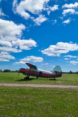 airplane on the green field. blue cloudy sky