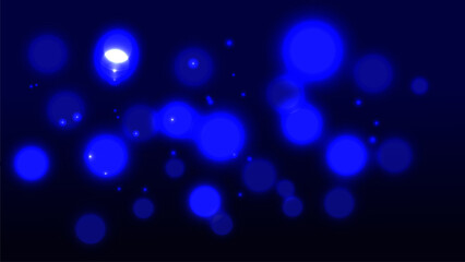 Abstract glowing blue bokeh light background with soft blur effect on a dark backdrop.