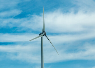Wind turbine under cloudy sky
