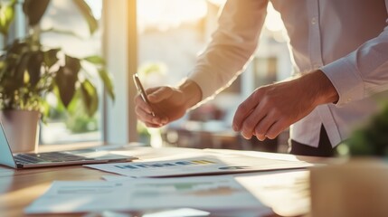 Professional working with data and charts in stylish office during sunset