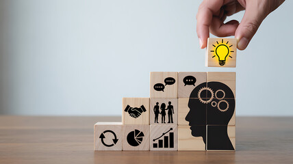 Hand placing last block in stair step of business growth and ideas