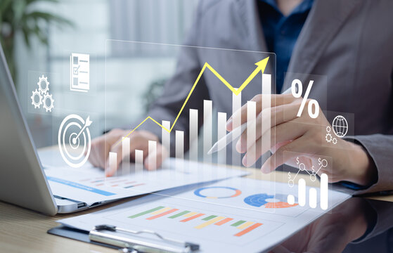 Businessman analyzing profit and quality management concepts long term cost planning, product quality, budgeting, financial forecasting, and company revenue and expense projections.