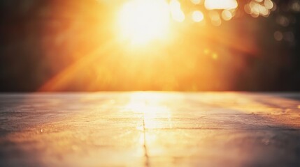 A wooden table with a warm, golden light shining through the trees, casting a soft glow on the surface.