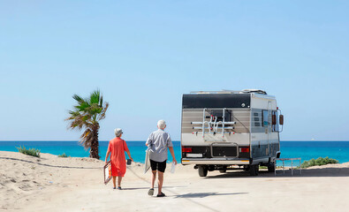 An elderly couple enjoys a carefree vacation by the sea