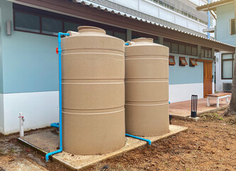 water tank and water pump installed outside the building. For use as a reserve of water for use in homes and offices. Made of special grade material, extra thick, UV protection and not moss.