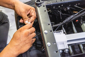 A skilled technician assembling and checking the electrical system and internal mechanism of an...