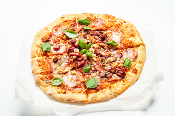 Delicious meat pizza with ham, salami and sausages.