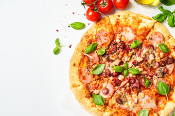 Delicious meat pizza with ham, salami and sausages.