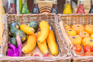 Colorful market stand featuring fresh tomatoes, eggplants, zucchinis. A vibrant showcase of organic produce emphasizing freshness and diversity of vegetables. High quality photo