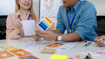 ux, ui, web and mobile app designers are discussing the look and feel of the website or app they...