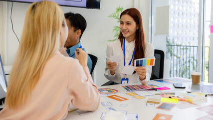 ux, ui, mobile app web designers are brainstorming to design a visual display that customers will...