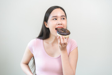 Portrait of attractive beautiful girl, pretty asian young teenage woman holding chocolate donut, doughnut, emotion enjoy sweet. Diet for loss weight to slim. Isolated white background, copy space.