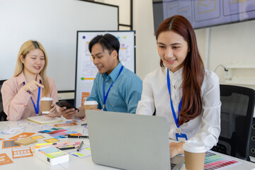 ux, ui, mobile app web designers are brainstorming to design a visual display that customers will...