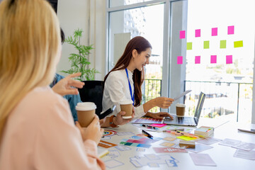 ux, ui, mobile app web designers are brainstorming to design a visual display that customers will...