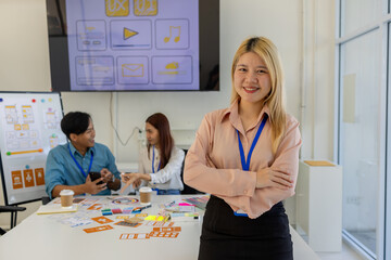 ux, ui, mobile application designer looks at the camera, web designer looks at the camera, working...