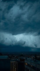 Dark, ominous clouds gather over the city skyline before the storm hits