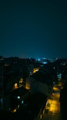Night scene shows city streets illuminated by streetlights and building lights
