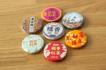 different types of traditional compressed chinese tea for tea ceremony, variety of teas, isolated on wooden background
