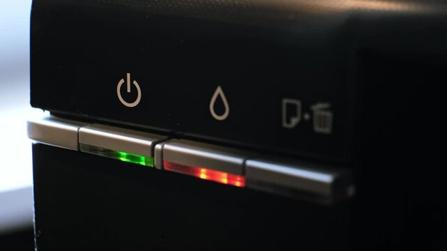 The green light on the printer is on and the red light is flashing, indicating a malfunction of the device or the need to refill it with ink. The need for office equipment maintenance. 4k footage.