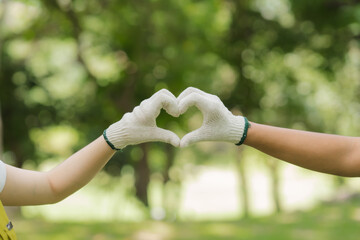 Hands Forming Heart Shape in Nature