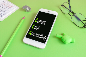 Current Cost Accounting symbol. Concept words CCA Current Cost Accounting written on the mobile...