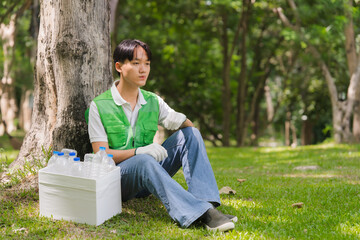 Volunteer Resting After Collecting Plastic Bottles in Park