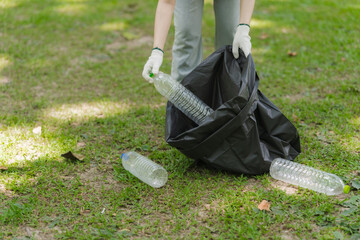 Volunteer Picking Up Plastic Bottles in Park