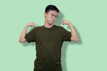 Confident Young Man Showing Strength on a Minimalist Background
