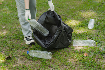 Person Collecting Plastic Bottles in Park