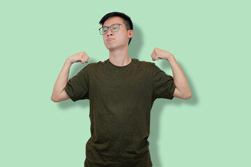 Confident Young Man Showing Strength on a Minimalist Background
