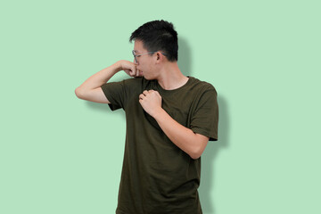 Confident Young Man Showing Strength on a Minimalist Background