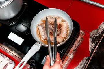 Asian Spring Roll Frying Process in Kitchen Cooking Scene